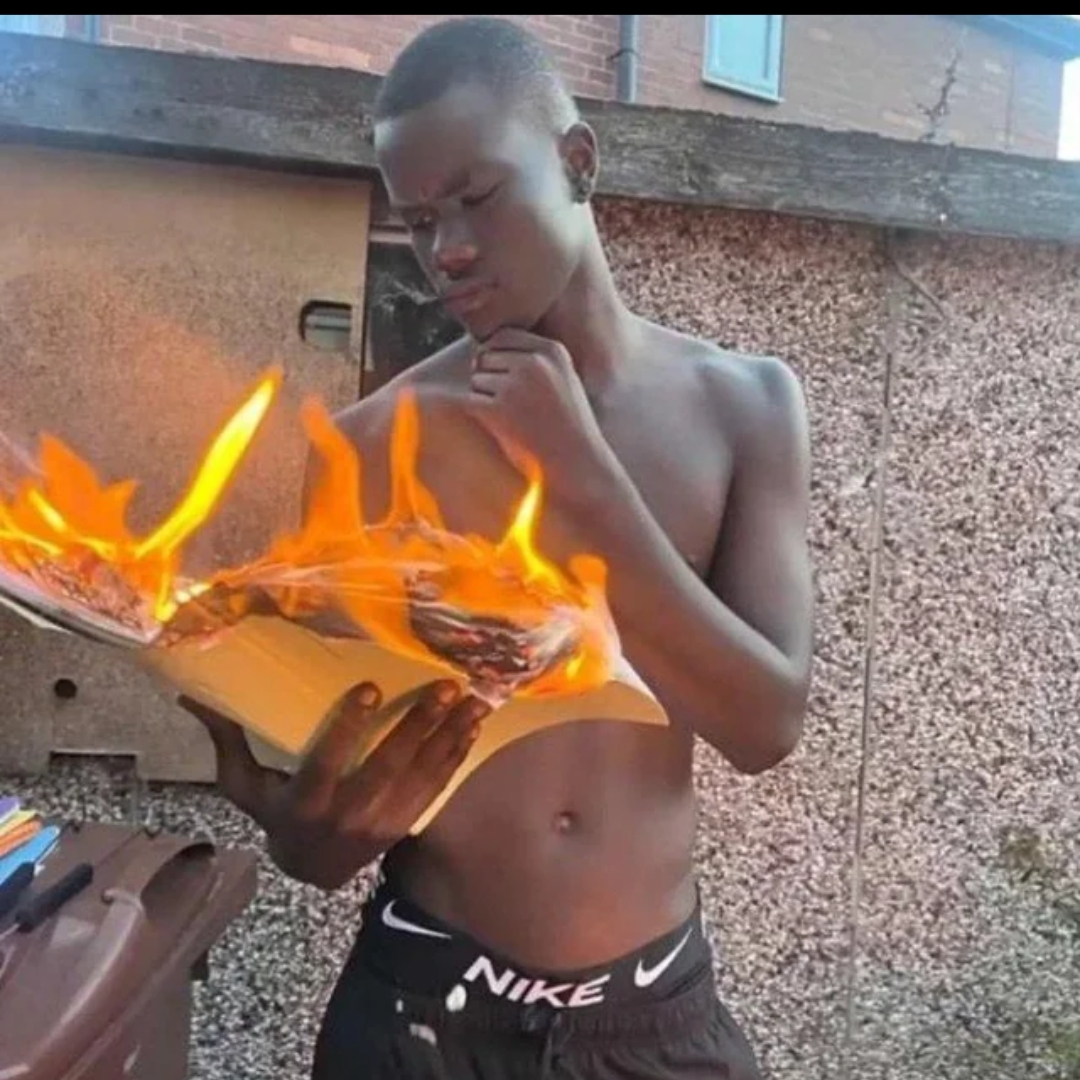 A person reading a book that is on fire